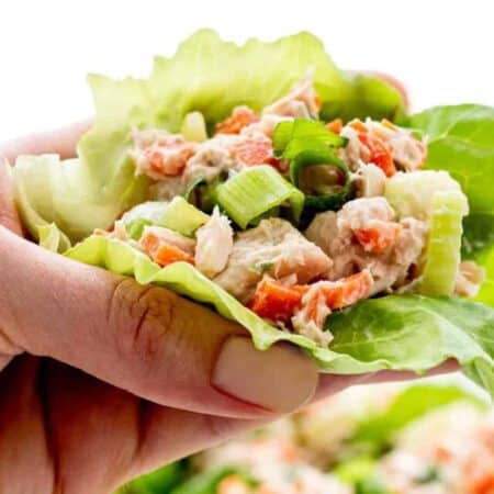 A hand holding one of the tuna lettuce wraps.