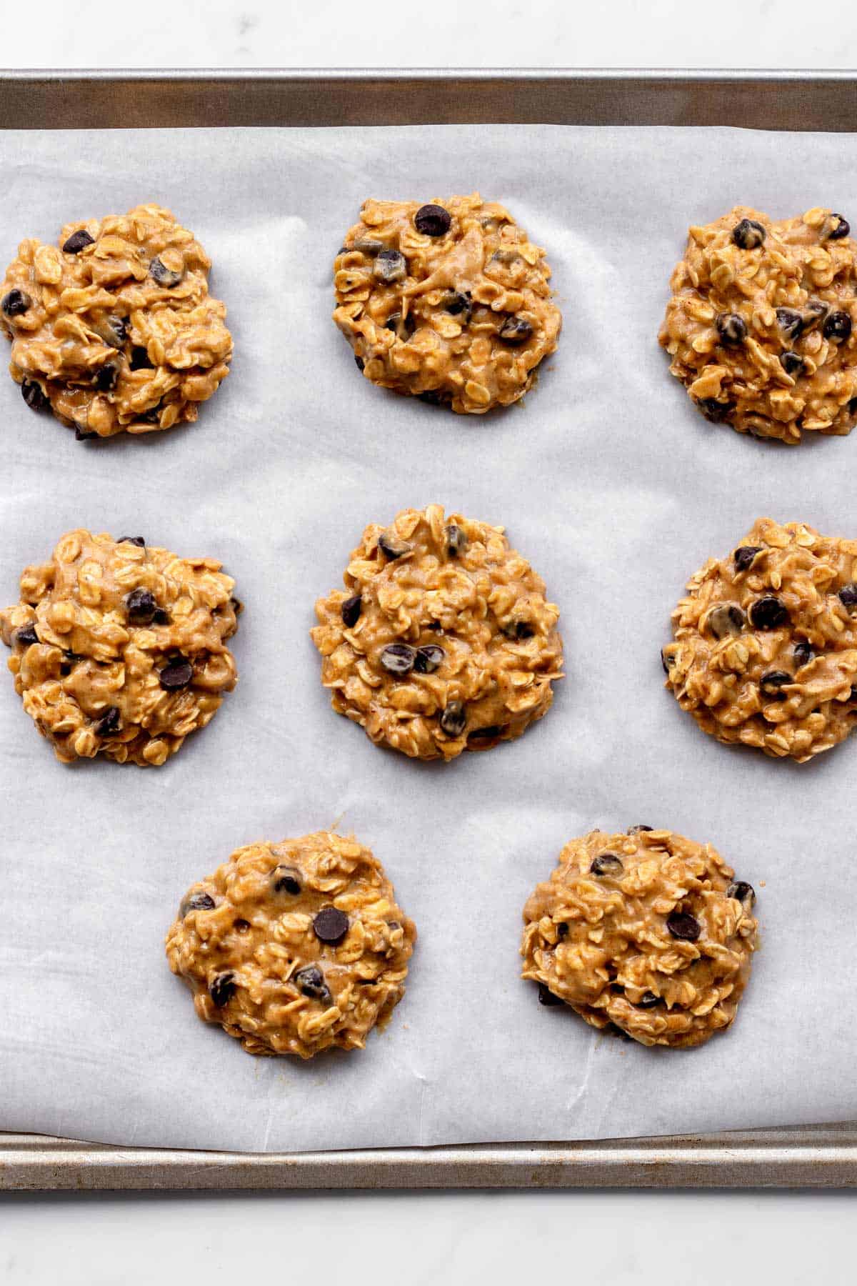 Cookie batter portioned out on a baking sheet ready to be baked.