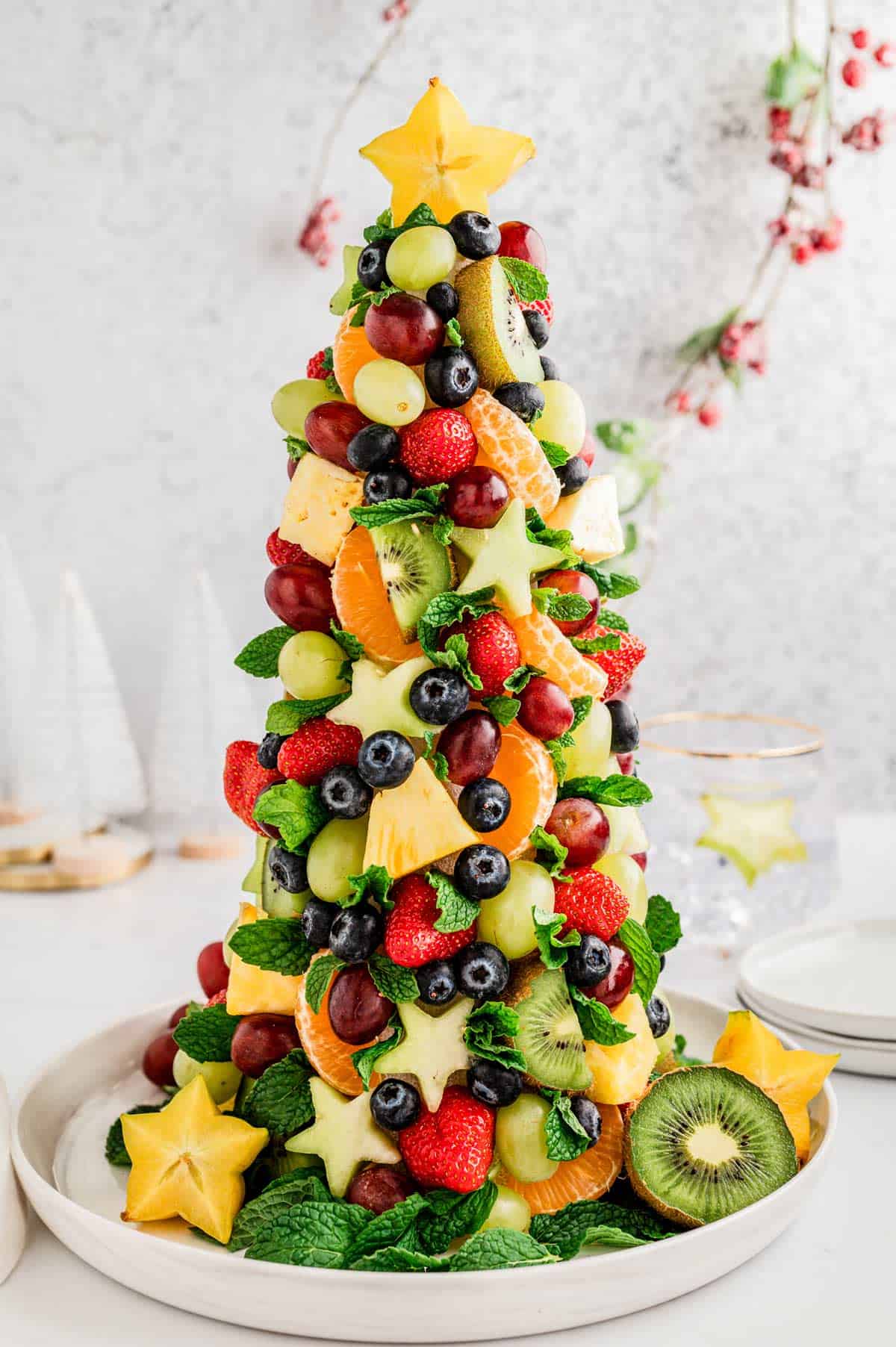 A fruit Christmas tree on a plate.