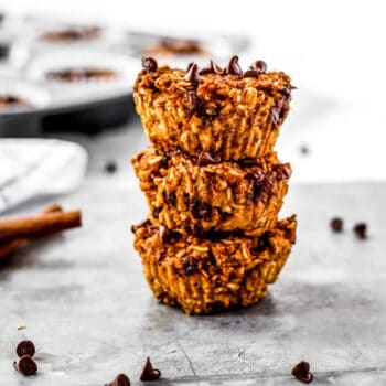 Three pumpkin oatmeal muffins stacked on top of each other.