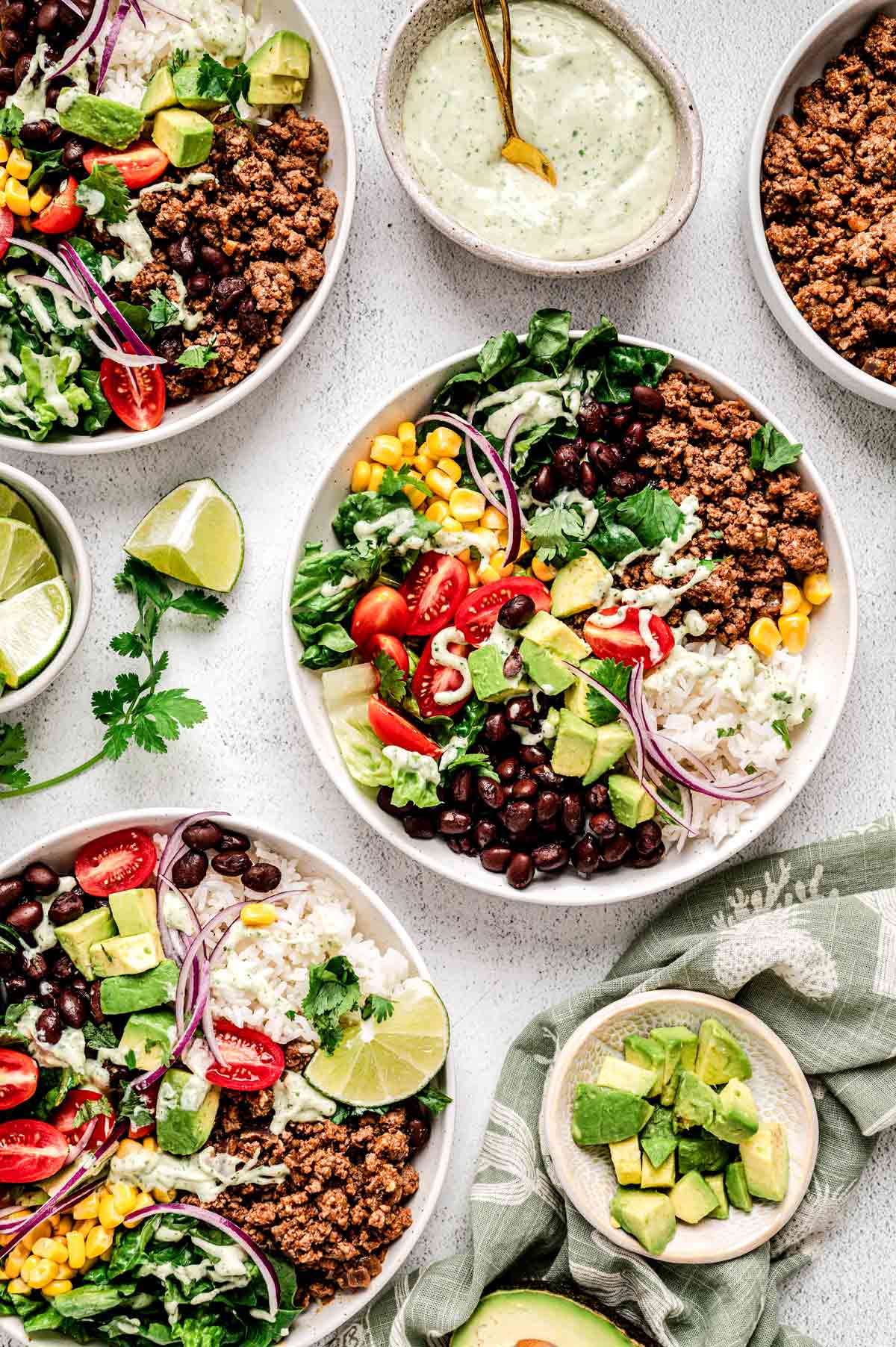 Bird's eye view of three ground beef taco bowls.