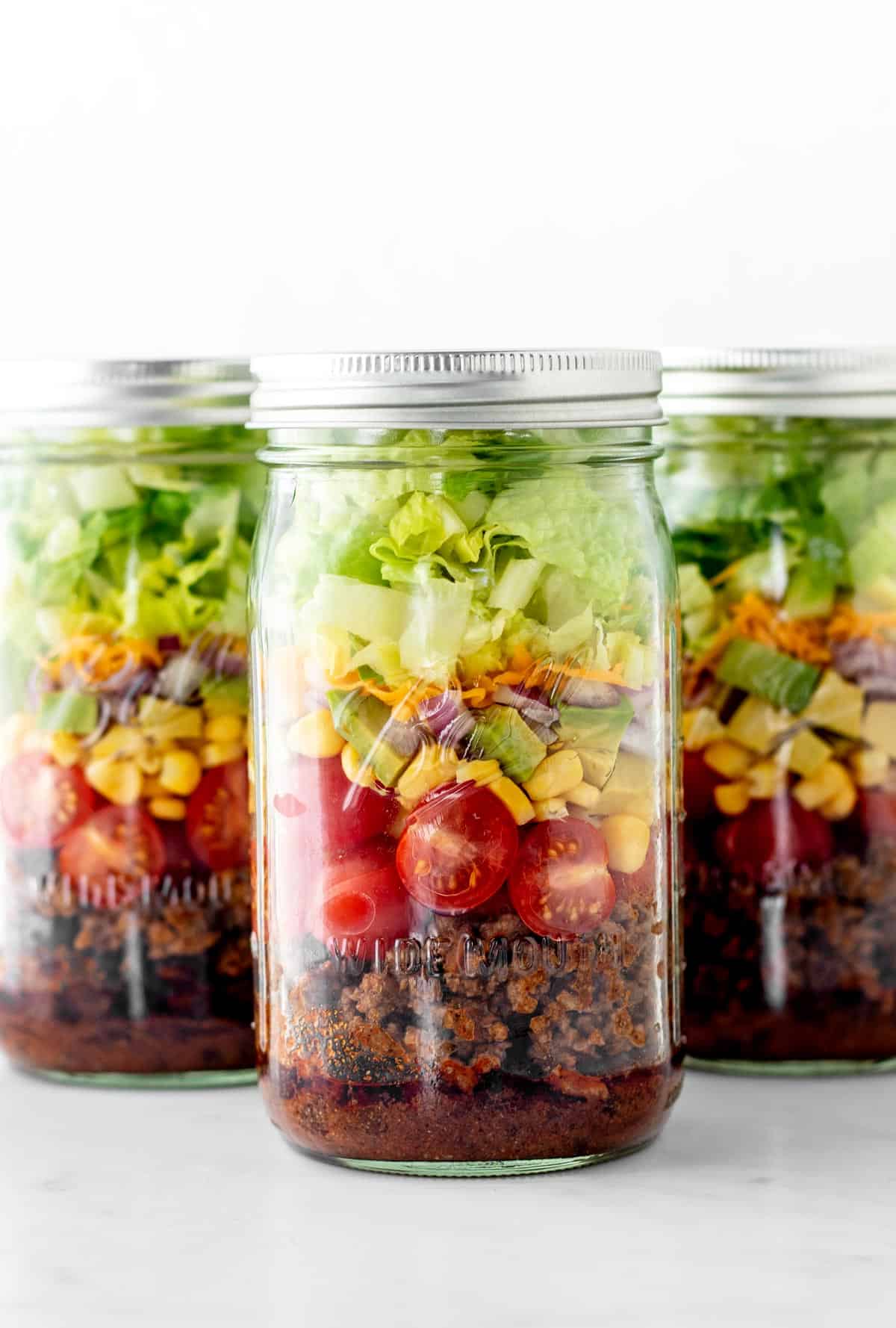 Three jars of mason jar taco salad.