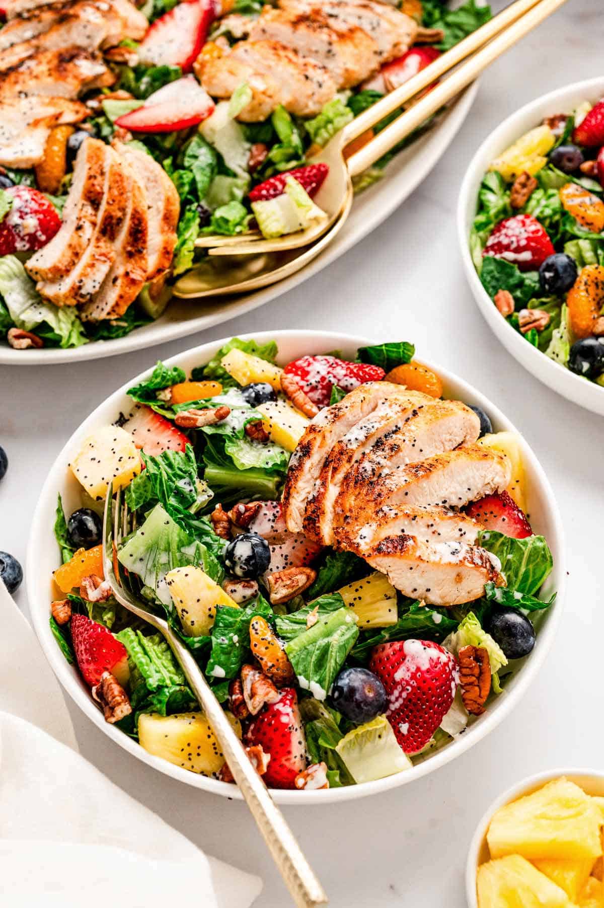 Copycat Panera strawberry poppyseed salad in a bowl with a fork.
