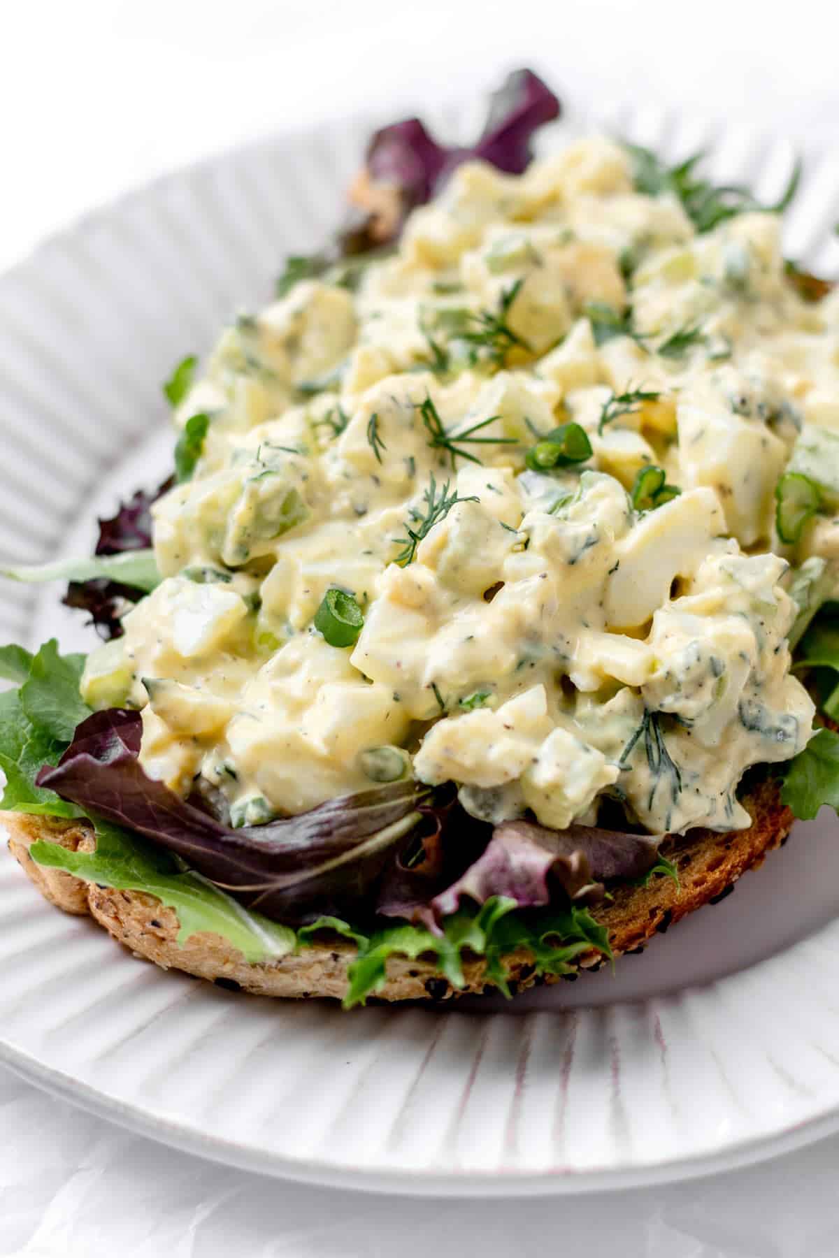 Cottage cheese egg salad on some greens and a slice of toast.