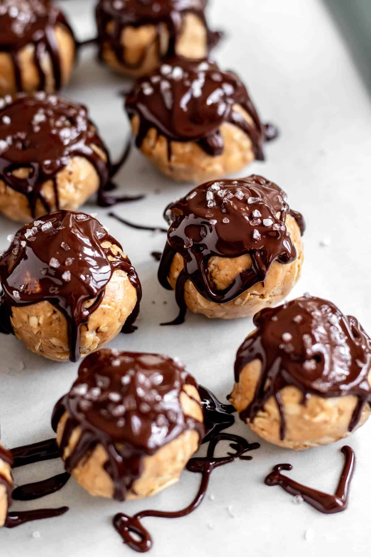 No bake peanut butter balls drizzled with melted chocolate.