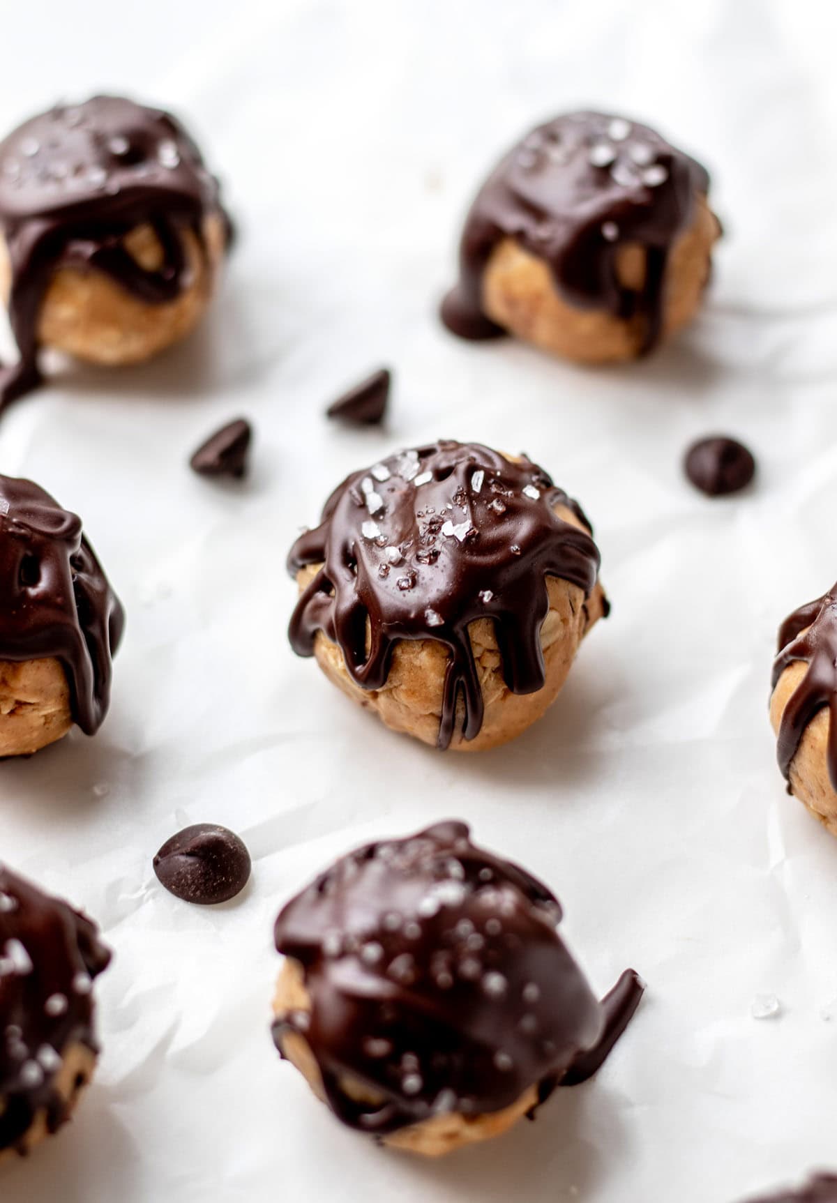 Chocolate peanut butter protein balls on parchment paper.