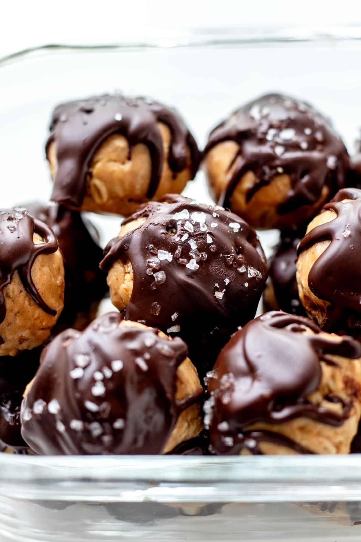 Up close image of chocolate and peanut butter protein balls in a meal prep container.