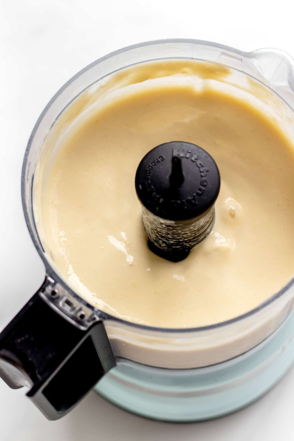 Whipped mango dole whip in a mini food processor.