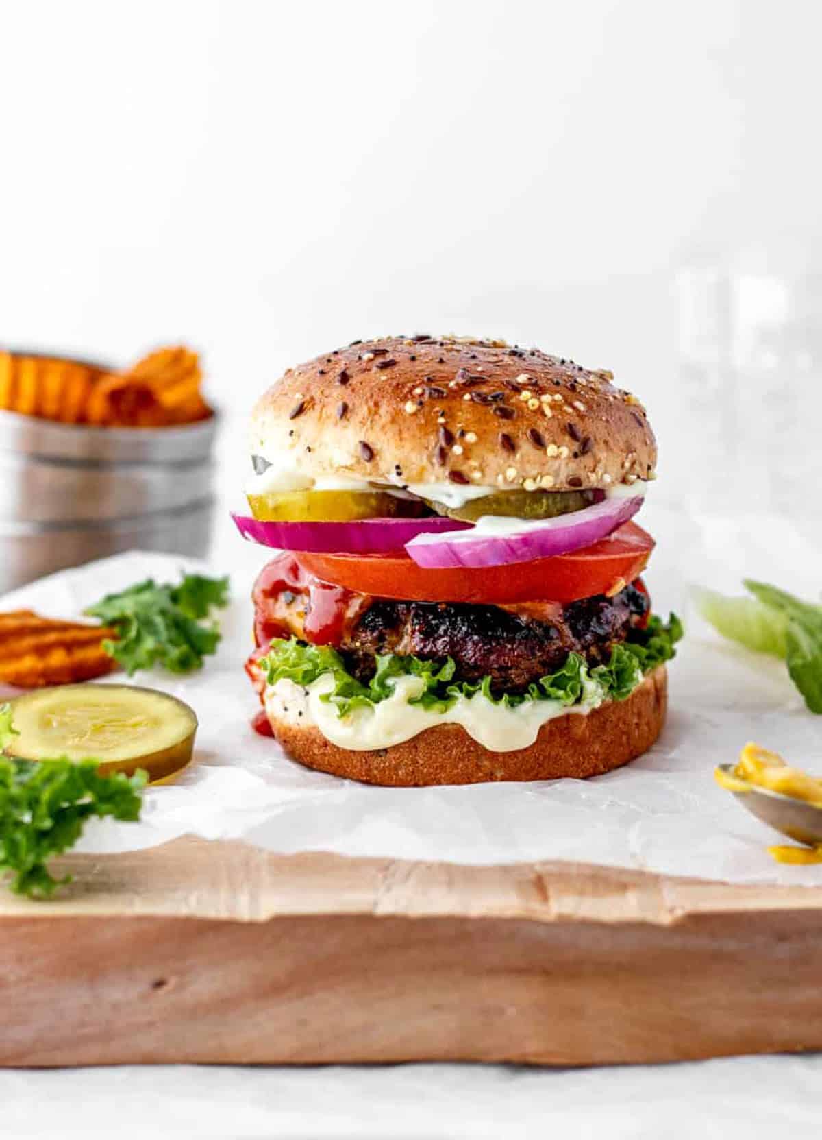 Healthy veggie bean burger with fresh vegetables and whole grain bun.