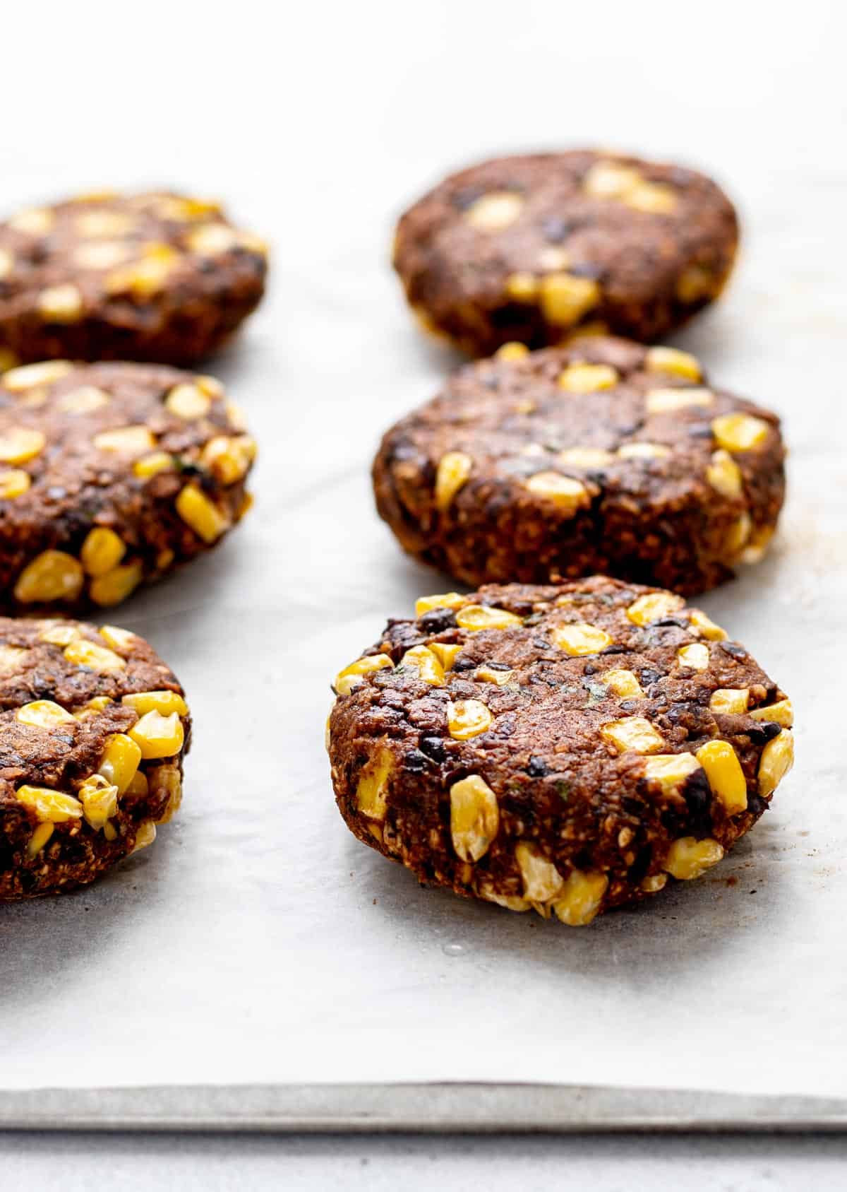 Cooked bean burgers on a baking sheet.