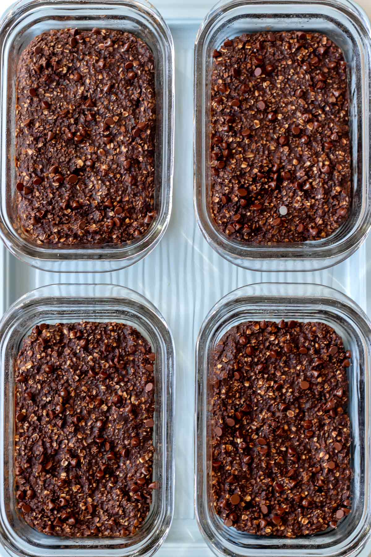 Bird's eye view of four chocolate protein baked oatmeal bowls.