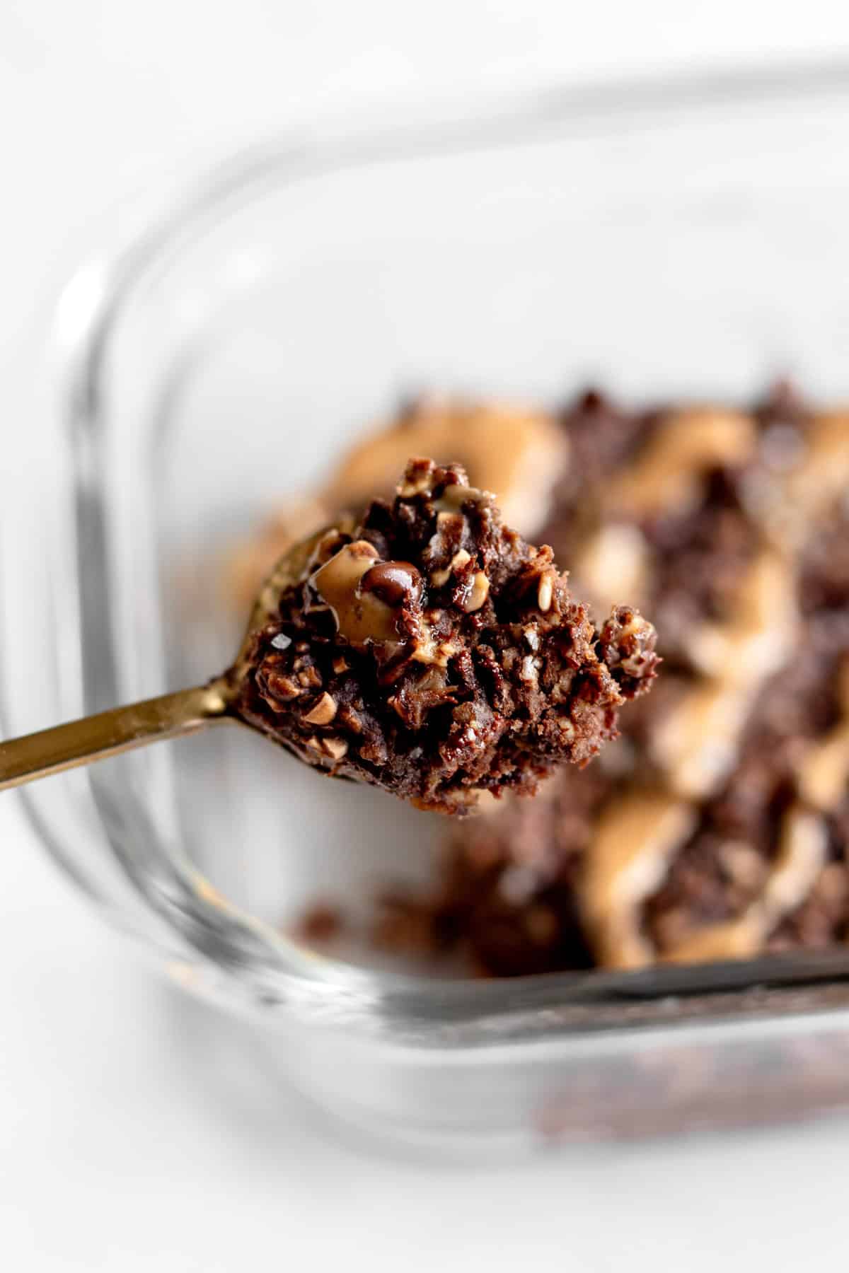 A spoon holding up some of the chocolate protein baked oats.